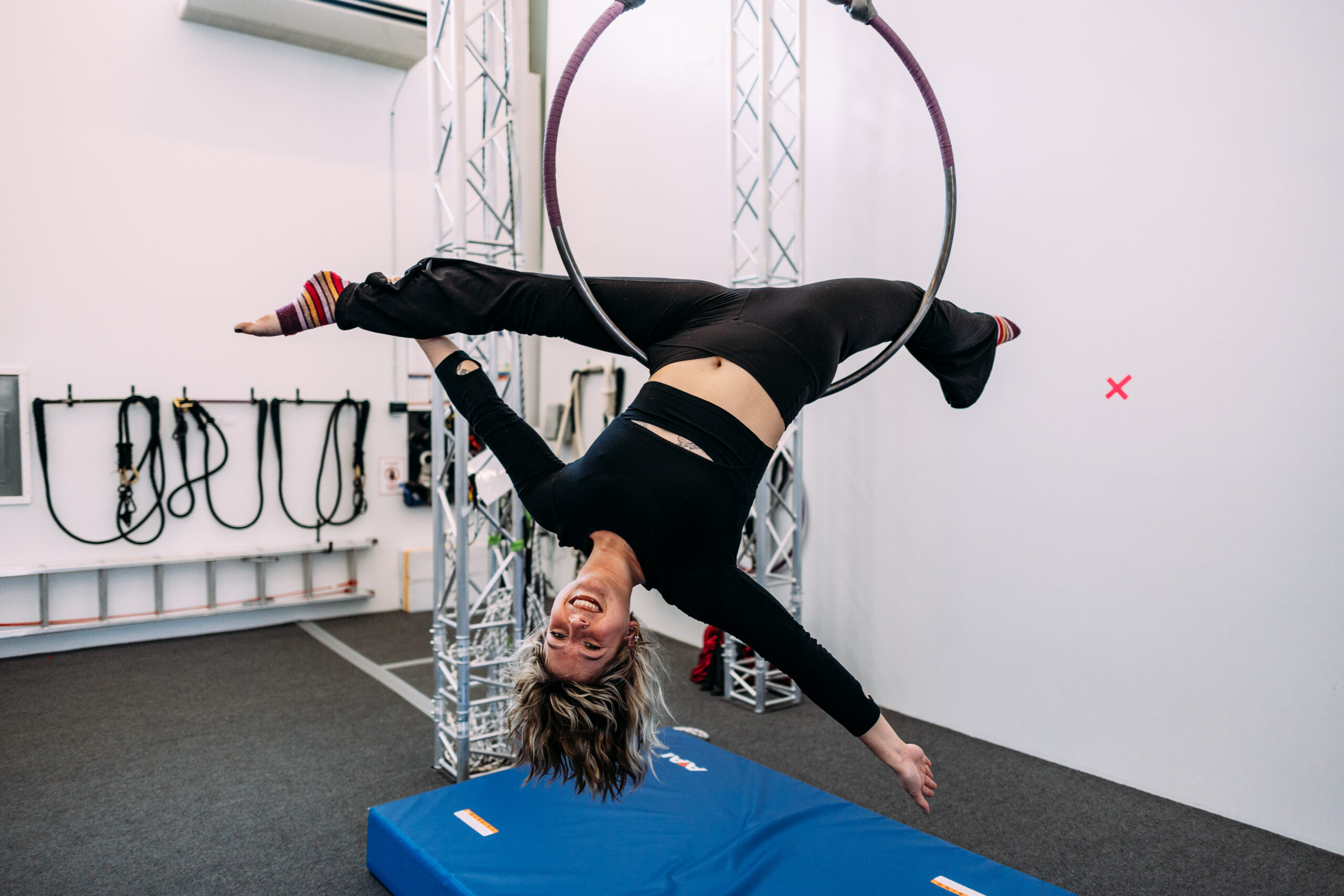 A adult on an aerial lyra hoop at aerial cirque over denver adult aerial dance classes
