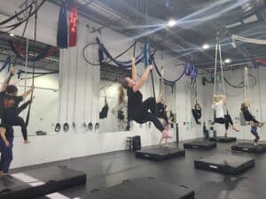 Denver bachelorette party on the aerial trapeze at Aerial Cirque Over Denver dance studio