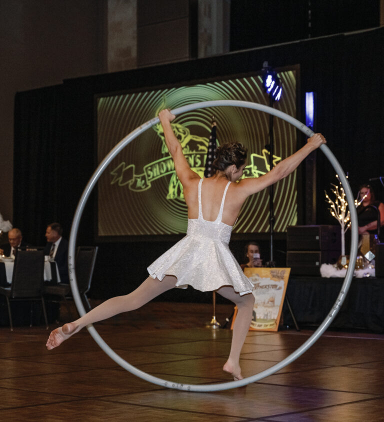 Cyr wheel artist spinning in large ring
