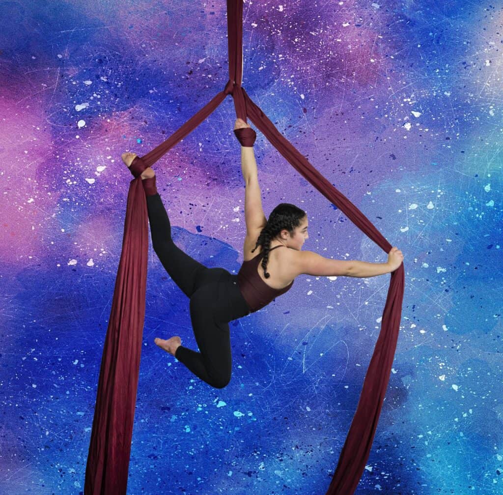 adult aerial silks classes women with muscles posing on silks in backbend