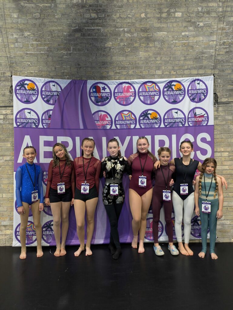 youth competition team at aerial cirque over denver at an in person competition. Here the whole team is shown at Aerialympic event.