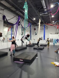 kids aerial class students working on silks